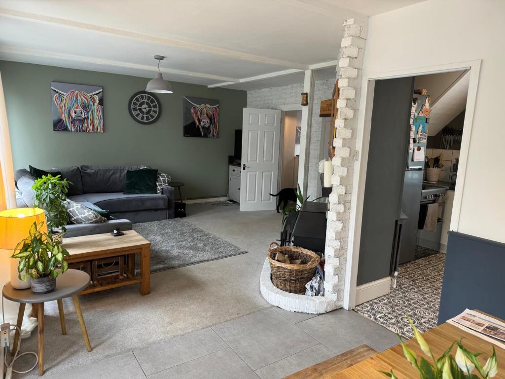 Lot: 55 - THREE-BEDROOM END-TERRACE HOUSE - reverse angle of dining and living room